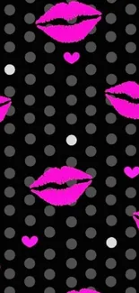 Neon pink lips and hearts on a black dotted wallpaper.