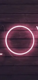 Neon love sign on dark wooden background.