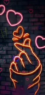 Neon hand and hearts graffiti on brick wall.