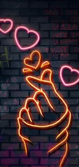 Neon hand with hearts on graffiti wall.