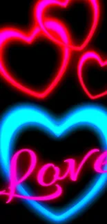 Neon love hearts and the word love in glowing colors on black background.