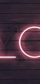 Pink neon love sign on wood background.