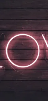 Pink neon 'Love' sign on dark wood background wallpaper.