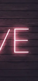 Neon love sign on a dark wooden wall background, perfect for mobile wallpaper.