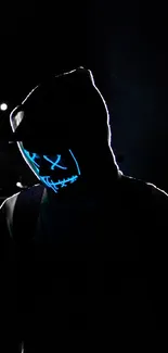 Mysterious figure wearing a glowing neon mask in the dark.