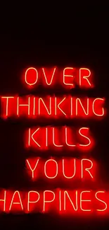 Bright red neon sign says: 'Overthinking kills your happiness.' Motivational wallpaper.