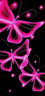 Vibrant neon pink butterflies on a black background.