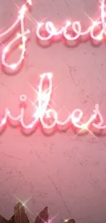 Neon pink 'Good Vibes' text on textured background.