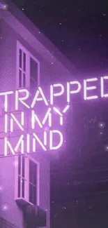 Neon purple sign reading 'Trapped in my mind' on a building wall.