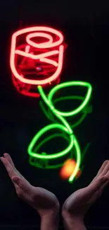 Neon rose with hands underneath on dark background.