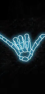 Neon skeleton hand gesture on dark background.