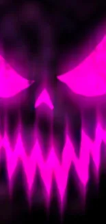 Neon skull with glowing magenta effect on a dark background.