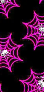 Neon pink spider web wallpaper on a black background.