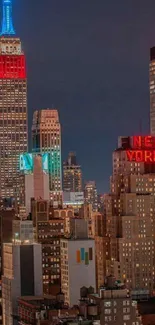 A night view of New York City skyline with colorful skyscraper lights.