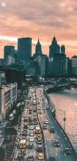 New York City skyline view at sunset with orange sky and calm waters.