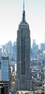 New York City skyline with iconic skyscrapers against a blue sky.