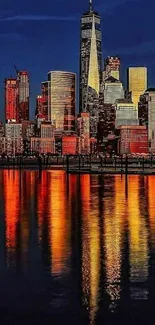 Nighttime New York skyline with reflections on water.