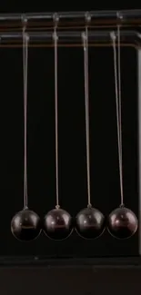 Newton's Cradle mobile wallpaper in motion, stylish and dynamic art.