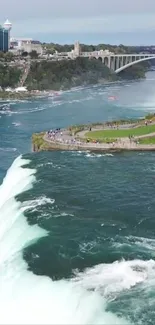 Niagara Falls with blue water and lush greenery in a scenic mobile wallpaper.