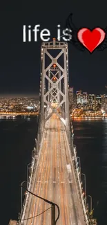 Lit bridge over water with heart design at night.