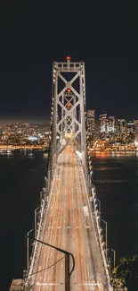 Captivating night view of a city bridge with lights and skyline in the background.