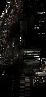 A vibrant city view from above at night with glowing streetlights.