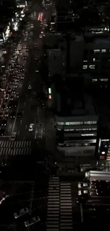 Aerial view of a city at night with illuminated streets.