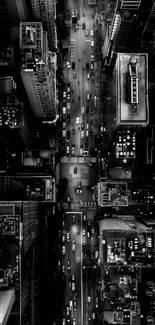 Aerial view of a vibrant city at night with illuminated streets and buildings.