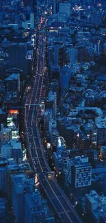 Aerial view of a vibrant city at night with illuminated streets.