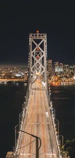 Illuminated bridge at night with city backdrop, showcasing urban elegance.