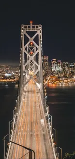 Night bridge with city lights reflected on water.