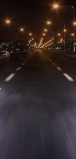 Night city highway illuminated by streetlights.