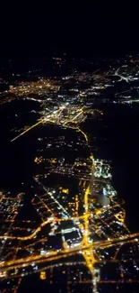 Aerial view of city lights at night from above.