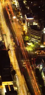 Aerial night view of vibrant city light trails.