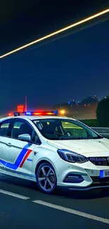 Police car under night sky with city lights.