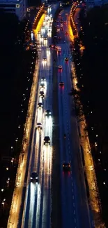 Aerial night view of a city road with vibrant lights.