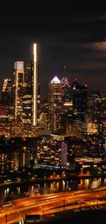 Dynamic city skyline at night with glowing lights and skyscrapers.