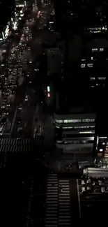 Aerial view of city streets illuminated at night.