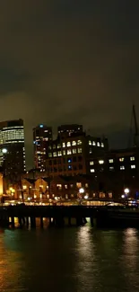 A night city skyline with reflections on water, illuminated by urban lights.