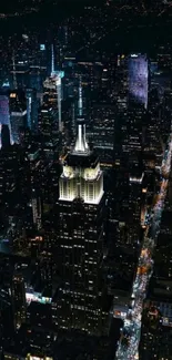 Aerial view of city skyline at night with illuminated skyscrapers.