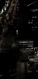 Aerial view of a city street at night with bright lights.