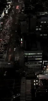 A vibrant city street at night with busy traffic and urban lights.