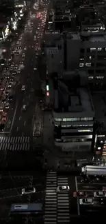 Aerial night view of city street with lights and traffic.