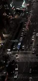 Nighttime view of a busy city street with cars and lights.