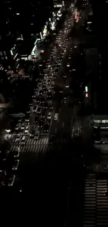 Overhead view of a busy night city street with lights and traffic.