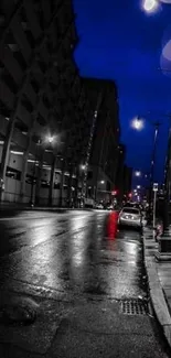 Peaceful night city street with lights and reflections on a quiet, rainy road.