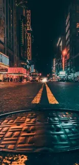 Vibrant street view of a city at night with bright lights and urban atmosphere.