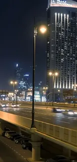 Night city skyline with illuminated streetlights and buildings.