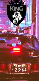 Neon-lit city street with black taxi and king logo.