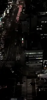 Nighttime cityscape with traffic lit streets and glowing urban buildings.